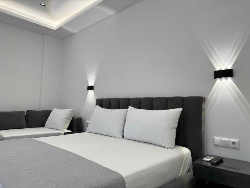 a bedroom with a bed with two lights above it at Ionian View B&B in Himare