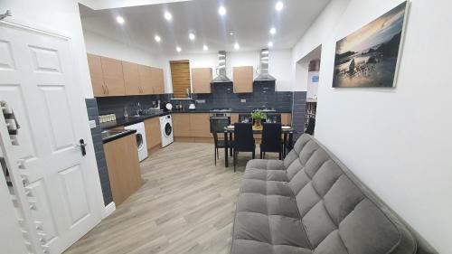 a kitchen and dining room with a table and chairs at Highfield House in Wellingborough