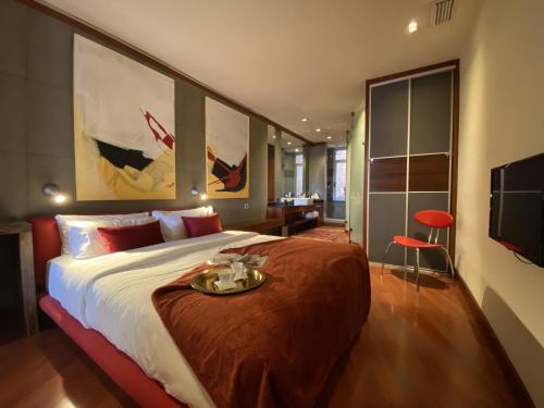 a bedroom with a large bed with a tray on it at Luminous Designer Loft Style Apt Eixample Views By MyRentalHost in Barcelona