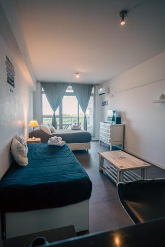 a living room with two beds and a table at Manzanares Suites in Buenos Aires