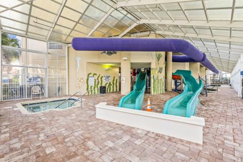a water slide in a building with a pool at Dunes Village/King bedOceanfront 2b/2b/waterpark in Myrtle Beach