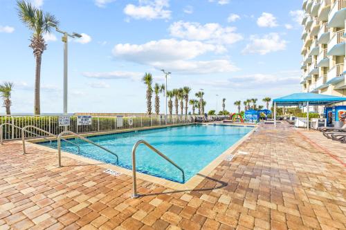 a swimming pool with palm trees and a playground at Dunes Village/King bedOceanfront 2b/2b/waterpark in Myrtle Beach