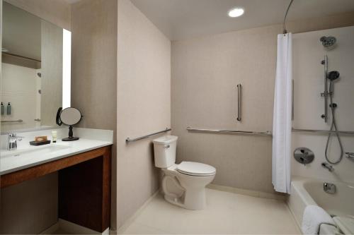 a bathroom with a toilet and a sink and a shower at Inn at Bellefield Residence Inn by Marriott in Hyde Park