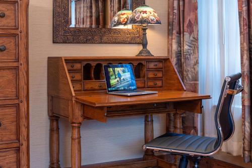 a desk with a laptop on top of it at Best Western Plus Waterbury - Stowe in Waterbury