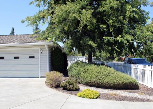 a house with a tree and a white garage at Tomodachi House - The Perfect Getaway for All! in Davis