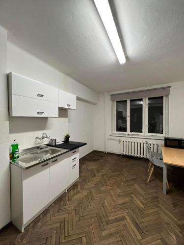 a kitchen with a sink and a table in a room at Nice flat in City Center Kraków in Krakow