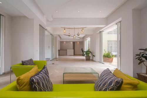 a living room with a green couch and a table at Kiluwa Apartments by Dunhill Serviced Apartments in Nairobi