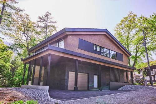 una casa con techo de gambrel en Zenrinso, en Hakuba