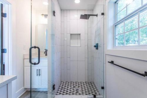 a bathroom with a shower with a glass door at GROVE PARK- ‘Newly Renovated’ home- just mins from Midtown/Downtown Atlanta. in Atlanta