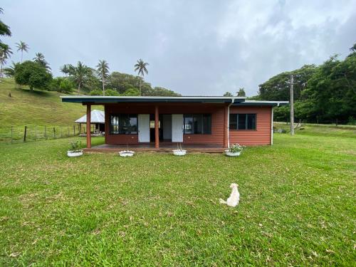 a small house in the middle of a field at Tobu House in Savusavu
