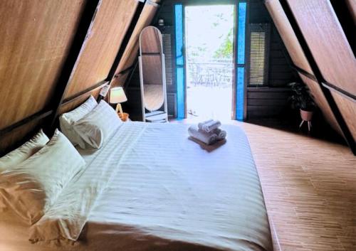 uma grande cama branca num quarto com uma janela em Rustcamps Glamping Resort em Genting Highlands