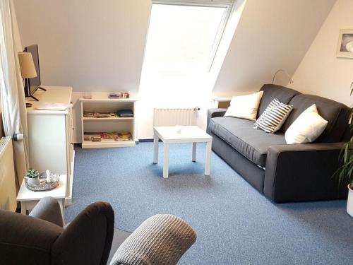 a living room with a couch and a table at Apartment in Lower Saxony in Halstenbek