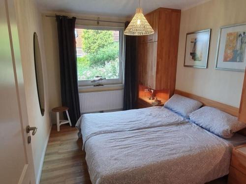 a bedroom with a bed and a window at Holiday apartment in Halstenbek in Schillig