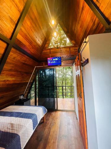 a bedroom in a tree house with a bed at Chalet Cerro azul in Cerro Azul