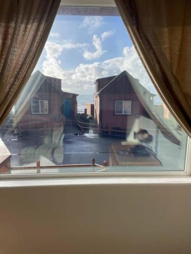 a view from a window of a house at Sand Castle - Ocean Cabin 25 W Private Jacuzzi in Smith River