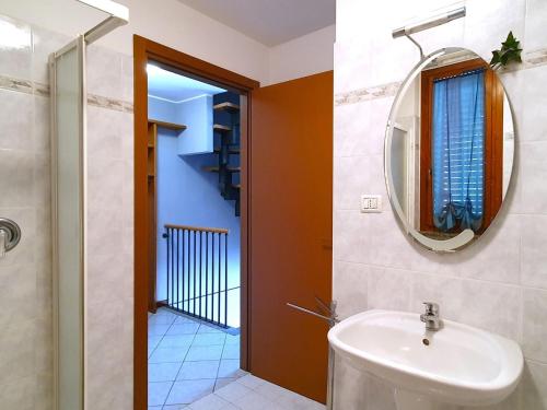 a bathroom with a sink and a mirror at Belvilla by OYO BOS03 3 in Grantola