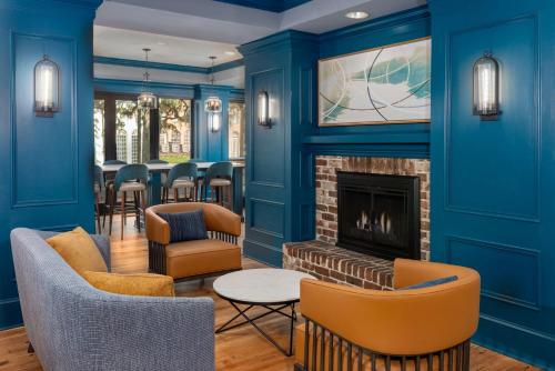 a living room with blue walls and a fireplace at Hampton Inn Savannah Historic District in Savannah