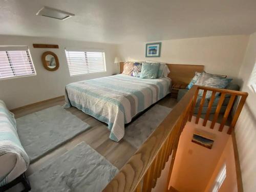 a bedroom with a bed and a chair in it at Oceanview Cabin 19,jacuzzi, Large Deck W Seating in Smith River