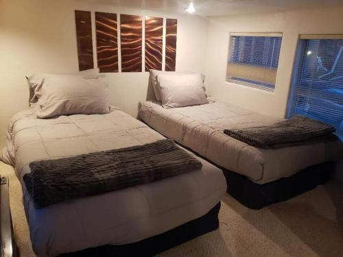 a bedroom with two beds and a window at Odysea Ocean Cabin 26 w Jacuzzi & Modern Decor in Smith River