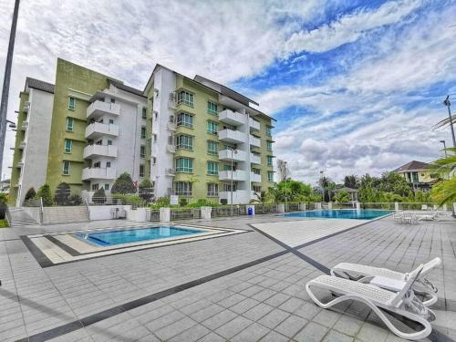 a building with a swimming pool in front of a building at EcoPark Condo, 5mins to airport, malls & eatery in Miri
