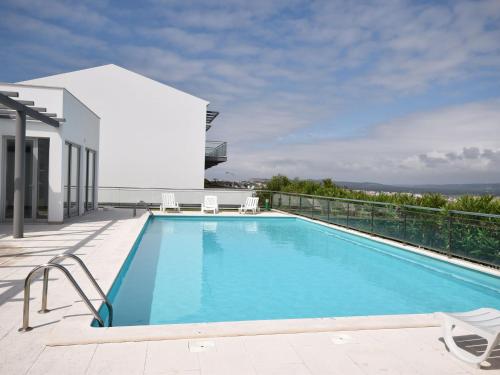 a swimming pool on the roof of a house at Holiday Home near São Martinho Beach in Salir de Porto