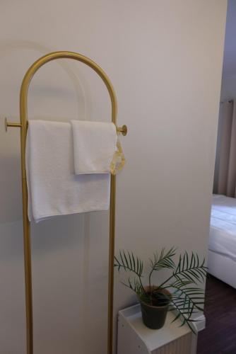 a towel rack with a towel in a bedroom at AboutTime Bangkok in Bangkok