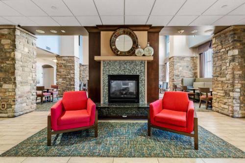 a lobby with two red chairs and a fireplace at Hampton Inn & Suites Colorado Springs-Air Force Academy/I-25 North in Colorado Springs