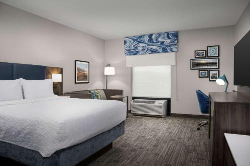 a hotel room with a bed and a desk at Hampton Inn Easton in Easton