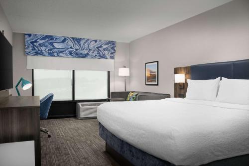 a hotel room with a large bed and a desk at Hampton Inn Easton in Easton