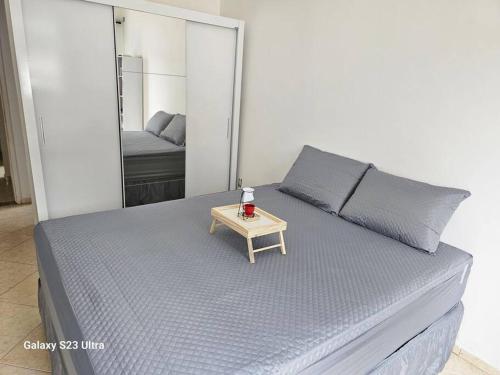 a bed with a small table on top of it at Imóvel com piscina e execelente estrutura ! in Araruama