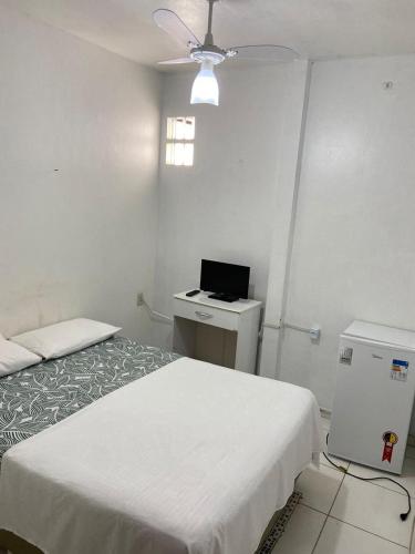 een kamer met 2 bedden en een laptop op een bureau bij Pousada Cantinho da Nilza in Cabo Frio