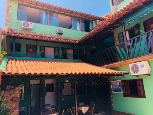 an old building with an orange tile roof at Pousada Cantinho da Nilza in Cabo Frio