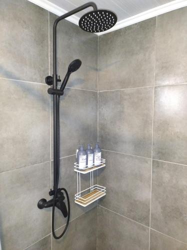 a shower with a shower head in a bathroom at La Vieja Finca in Ciudad Lujan de Cuyo
