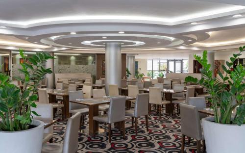 a conference room with tables and chairs and plants at Radisson Blu Hotel Lusaka in Lusaka