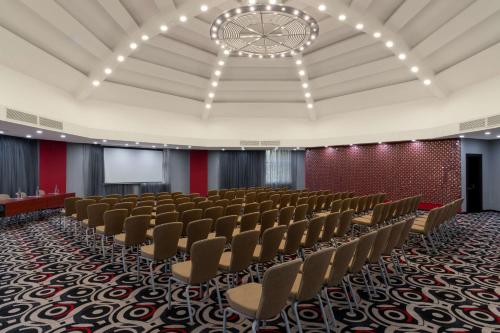 a conference room with chairs and a projection screen at Radisson Blu Hotel Lusaka in Lusaka