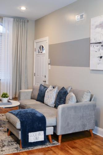 a living room with a couch and a table at Beautiful Irving two bedroom apartment in Philadelphia