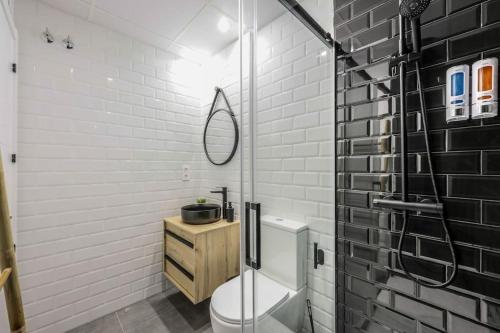 a bathroom with a shower and a toilet and a sink at Luxe apartments Madrid Rio by RentitUP in Madrid