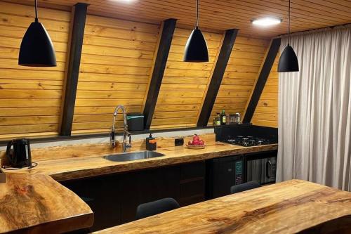 a kitchen with a sink and a counter top at Winter Valley Cabins in São Joaquim