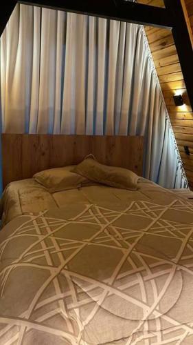 a bed in a room with a mosquito net at Winter Valley Cabins in São Joaquim