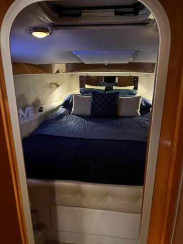 a small bed in the back of a van at LUXURY 40 FOOT YACHT ON 5 STAR OCEAN VILLAGE MARINA SOUTHAMPTON - minutes away from city centre and cruise terminals - Free parking included in Southampton