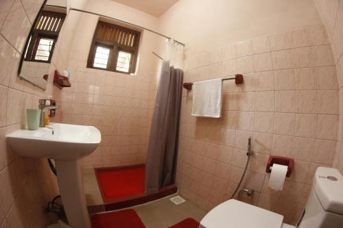 a bathroom with a sink and a toilet and a shower at Oasis Colombo in Colombo