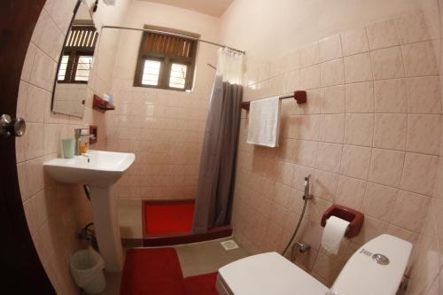 a bathroom with a toilet and a sink at Oasis Colombo in Colombo