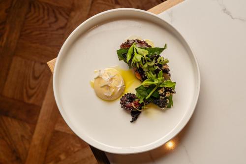 a white plate with food on a table at Novotel Sydney City Centre in Sydney