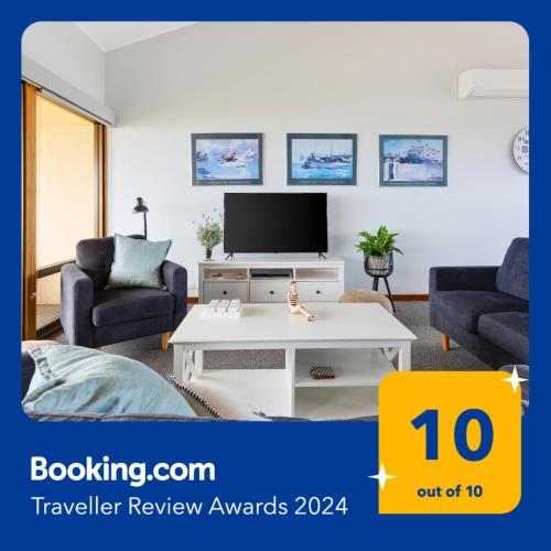 a living room with a tv and a white coffee table at Esplanade 3BR Holiday Home with Magic Ocean Views in Encounter Bay