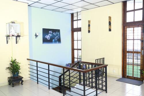 a lobby with a spiral staircase and windows at Oasis Colombo in Colombo