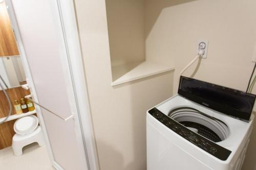 a washer and dryer in a small room at Bon condomium Umeda - Vacation STAY 8385 in Osaka