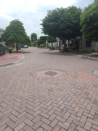 a brick road with a man hole in the middle at Family Home in Guayaquil in Guayaquil