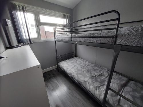 a room with two bunk beds and a window at 350 Golden Sands in Withernsea