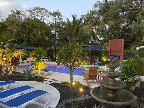 a fountain in the middle of a yard with a pool at The Agustin Guesthouse - Men Only Clothing Optional in Fort Lauderdale