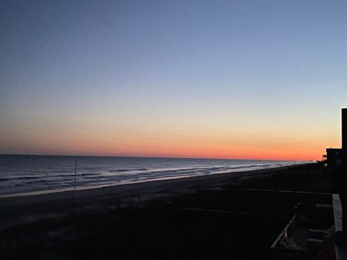 a view of the beach at sunset at 2 if by Sea- East Unit in Emerald Isle